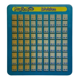 May include: A blue and yellow plastic learning toy with the words "Magic Math" and "Division" printed on it. The toy has a grid of squares with numbers and math equations printed on them.