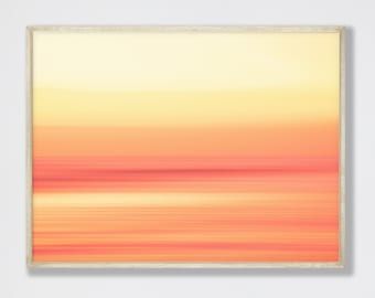 May include: A framed abstract art print with a horizontal, blurred, gradient design in shades of yellow, orange, and red.