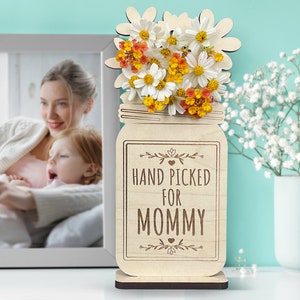 May include: Wooden cutout of a mason jar with flowers and the text "HAND PICKED FOR MOMMY".