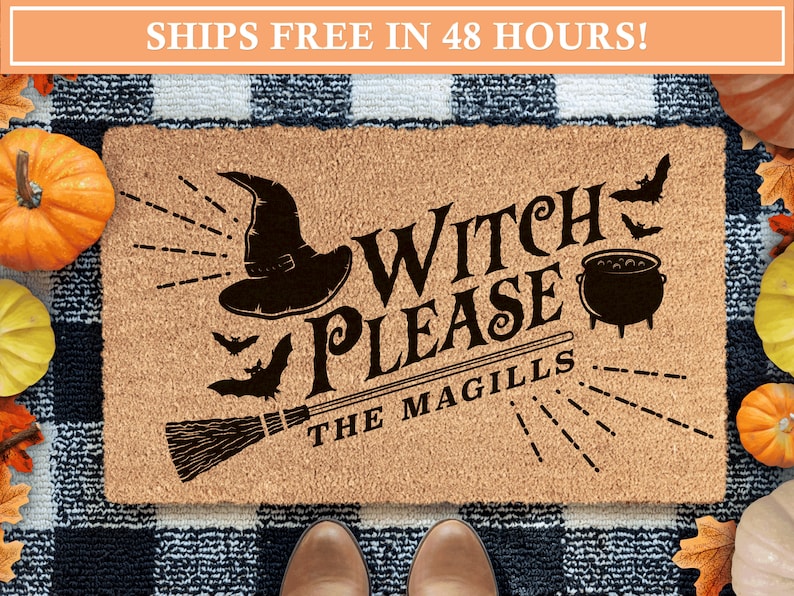 May include: A brown coir doormat with the text "Witch Please The Magills" in black. The doormat features a black witch's hat, a broom, a cauldron, and bats.