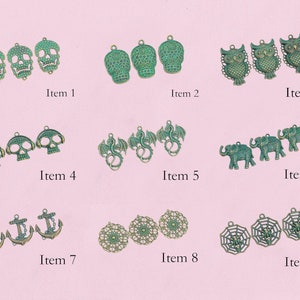 May include: Assortment of nine different charm pendants, including skulls, owls, dragons, elephants, anchors, and spiderwebs. The charms are made of metal and have a green and gold finish.