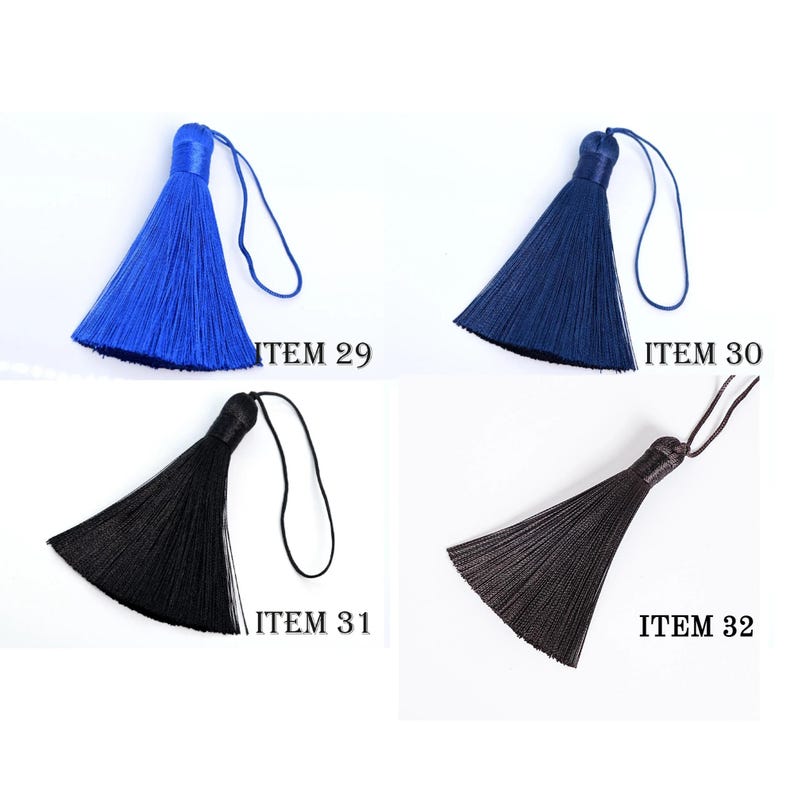 May include: Four colorful tassels in blue, navy, black, and dark brown, each with a looped cord. The tassels are labeled with the item numbers 29, 30, 31, and 32. The tassels are likely for crafts or decorative purposes.