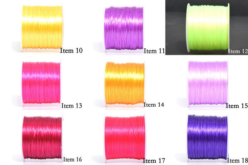 May include: A collection of colorful elastic string spools in various shades, including yellow, purple, green, pink, orange, and red. Each spool is labeled with an item number, offering a range of options for crafting and jewelry making.