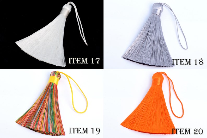May include: Four decorative tassels in white, silver, multicolored, and orange. Each tassel has a loop for hanging and a decorative top. The image includes the text "ITEM 17", "ITEM 18", "ITEM 19", and "ITEM 20".