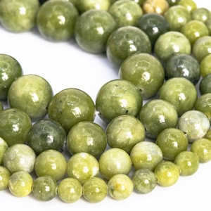 May include: A strand of round, green jade beads. The beads are smooth and polished, with a slight variation in color.