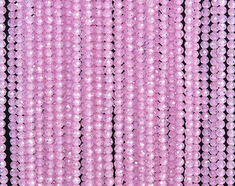 May include: A strand of pink faceted glass beads. The beads are small and round, and they have a shiny, iridescent finish.
