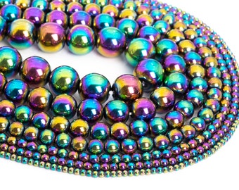 May include: A collection of iridescent rainbow hematite beads in various sizes. The beads are round and smooth, with a metallic sheen.
