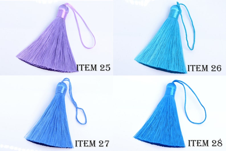 May include: Four colorful tassels in shades of purple, turquoise, and blue. Each tassel has a looped cord and a cylindrical top. The text "ITEM" followed by a number is printed near each tassel.