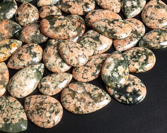 May include: A collection of green and pink agate gemstone pendants in a teardrop shape. The stones have a mottled, marbled appearance.