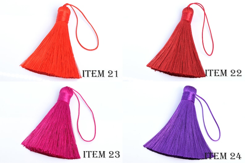 May include: Four colorful tassels in red, burgundy, fuchsia, and purple. Each tassel has a looped string for hanging and is labeled with the text "ITEM" followed by a number. The tassels are made of a silky material.