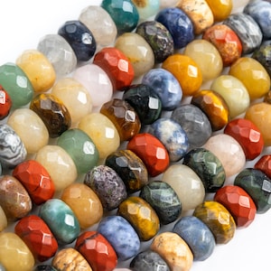 May include: A strand of faceted gemstone beads in various colors, including green, blue, red, yellow, and brown. The beads are arranged in a row and are all approximately the same size.