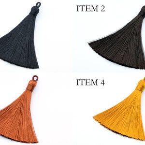 May include: Four different colored tassels, black, brown, orange, and yellow.  ITEM 1, ITEM 2, ITEM 3, and ITEM 4 are labeled above each tassel.
