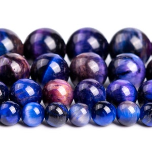 Peut inclure: Un brin de perles en &oelig;il de tigre bleu et violet. Les perles sont rondes et lisses, avec une finition brillante.