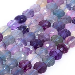 Può includere: Fili di perline di fluorite sfaccettate nei toni del viola, lavanda e blu. Le perline sono rotonde con un taglio sfaccettato, creando un effetto scintillante. Le perline sono infilate, pronte per la creazione di gioielli.