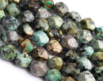May include: A strand of turquoise gemstone beads, each bead is faceted and has a unique pattern of green, brown, and black. The beads are irregular in shape and have a rough, natural texture.