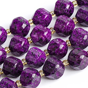 May include: A strand of faceted, deep purple gemstone beads with dark inclusions, separated by small, polished gold-tone metal spacer beads. The beads have a multi-faceted surface that reflects light, creating a textured appearance across the strand.