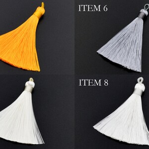 May include: Four different colored tassels, each with a loop at the top. The tassels are yellow, gray, white, and white. The tassels are labeled "ITEM 5", "ITEM 6", "ITEM 7", and "ITEM 8".