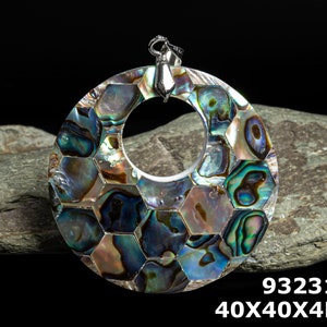 May include: A round, iridescent abalone shell pendant with a hexagonal pattern. The pendant is 40mm in diameter and 4mm thick. It has a silver bail and is perfect for jewelry making.
