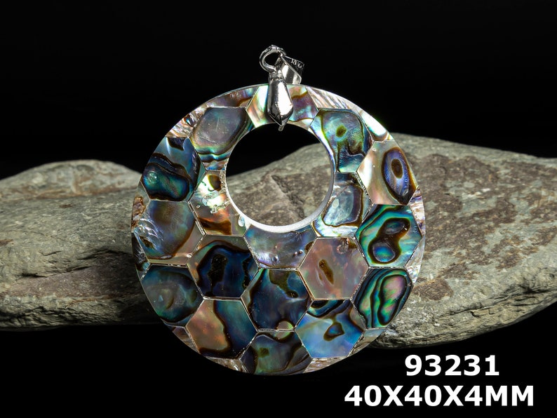 May include: A round, iridescent abalone shell pendant with a hexagonal pattern. The pendant is 40mm in diameter and 4mm thick. It has a silver bail and is perfect for jewelry making.