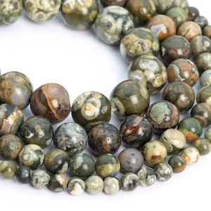 May include: A strand of green, brown, and white patterned gemstone beads. The beads are round and have a speckled appearance.