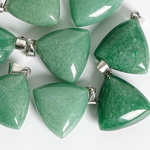 May include: A collection of triangular green aventurine pendants, each featuring a polished, smooth surface with natural mineral inclusions and a silver-toned metal bail attached to the top corner for hanging on a necklace chain or cord.
