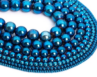 May include: A collection of blue metallic beads of varying sizes, arranged in a circular pattern. The beads are smooth and shiny, with a metallic finish.