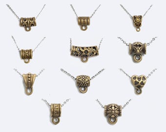 May include: Assortment of 10 gold-tone metal pendant necklace end caps with various ornate designs. The end caps are designed to be used as a connector for a necklace or bracelet.