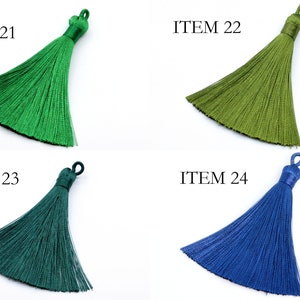 May include: Four different colored tassels, labeled ITEM 21, ITEM 22, ITEM 23, and ITEM 24. The tassels are green, olive green, dark green, and blue.