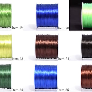 May include: Collection of spools of colorful beading thread. Colors include green, blue, and brown. Each spool is labeled with an item number. Ideal for jewelry making and crafting projects.