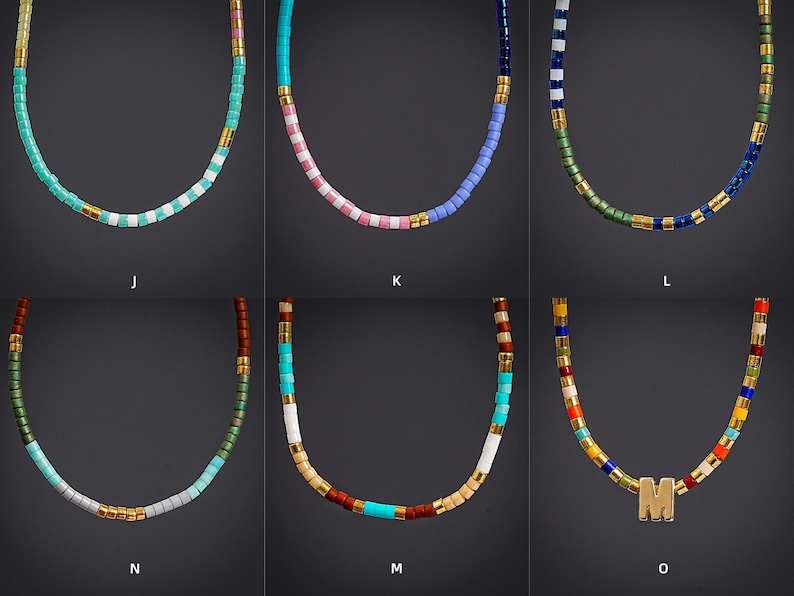 May include: Six colorful beaded necklaces with gold accents. The necklaces feature various color combinations, including turquoise, pink, blue, green, and a multi-colored option. One necklace has a gold letter "M".