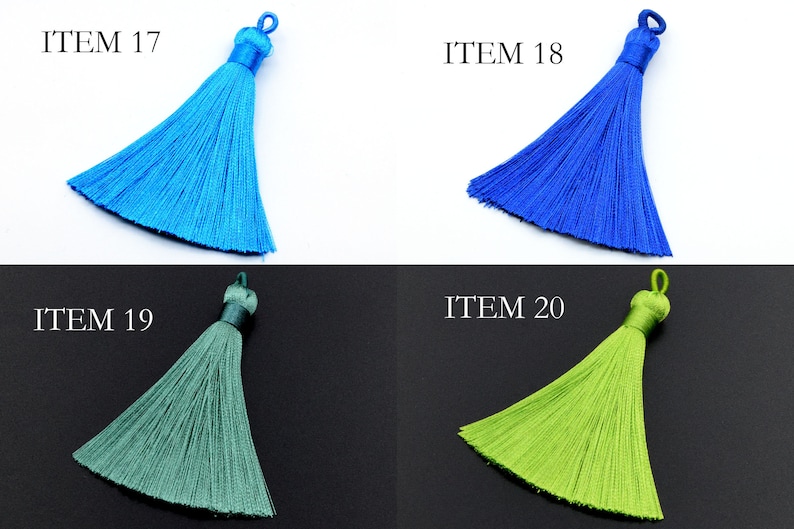 May include: Four tassel trims in different colors: light blue, royal blue, teal green, and lime green. The tassels are all the same size and shape, with a loop at the top for attaching.