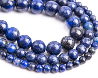 May include: A strand of deep blue lapis lazuli beads with gold flecks. The beads are round and vary in size, creating a layered effect.