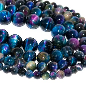 May include: A strand of round, iridescent blue, purple, and gold tiger's eye beads. The beads are strung on a clear cord and are approximately 10mm in diameter.