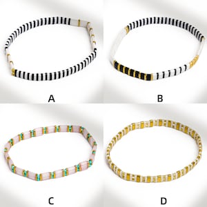 May include: Four beaded bracelets in a square format. The bracelets feature different color combinations: black and white, white and black, pink and turquoise, and gold and white. Each bracelet is made of small, rectangular beads.