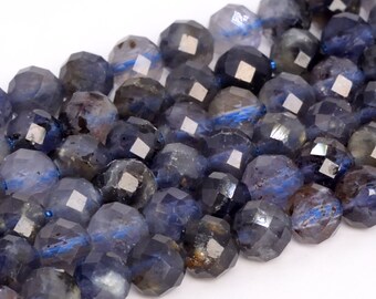 May include: A strand of faceted blue gemstone beads. The beads are a dark blue color with a slight shimmer. The beads are all approximately the same size and shape.