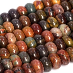 May include: A strand of colorful, round, polished gemstone beads. The beads are a mix of brown, red, and green with a mottled pattern.