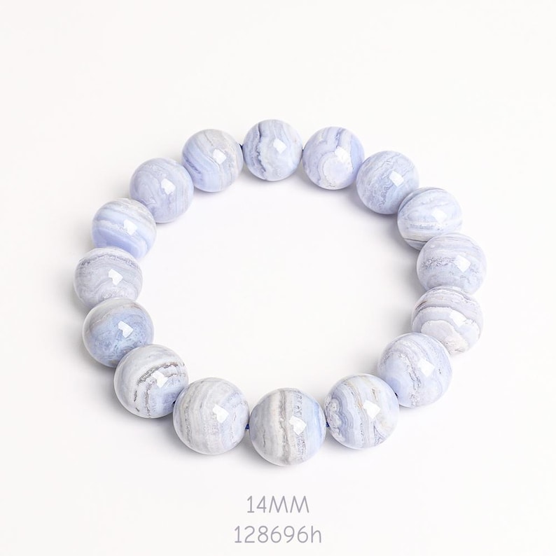May include: A bracelet made of round, light blue agate beads. Each bead is approximately 14mm in diameter and features a unique pattern of white and gray swirls. The bracelet is displayed on a white background.