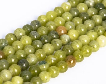 May include: A strand of round, green jade beads. The beads are smooth and polished, with a slight variation in colour.