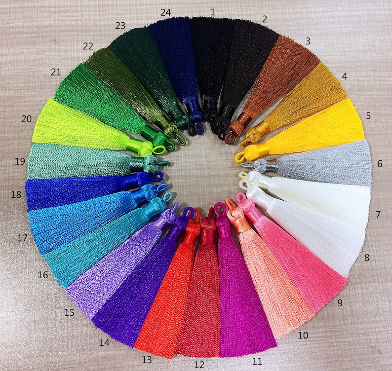 May include: A set of 24 colorful tassels arranged in a circle. The tassels are made of a soft, silky material and are available in a variety of colors, including black, green, blue, red, and yellow.