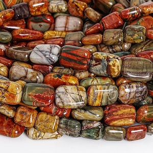 May include: A collection of polished gemstones in various colors, including red, brown, green, and yellow. The stones are rectangular and oval-shaped, with unique patterns and textures. The gemstones are likely used for jewelry or decorative purposes.