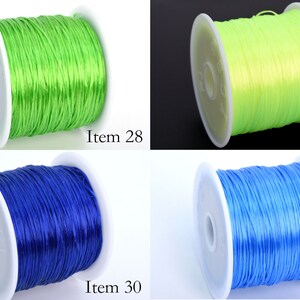 May include: Four spools of elastic cord in different colors: green, yellow, blue, and light blue. Each spool is labeled with an item number.