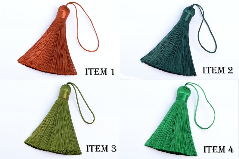 May include: Four colorful tassels in shades of orange, dark green, olive green, and bright green. Each tassel has a matching loop and a wrapped top. The text "ITEM" followed by a number is printed next to each tassel.