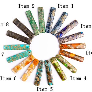 May include: A set of 9 colorful, rectangular, gemstone cabochons with gold flecks. The cabochons are arranged in a circle on a white background. Each cabochon is labeled with a number from 1 to 9.