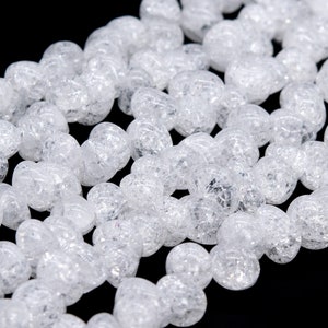 May include: A strand of clear, faceted, crystal beads. The beads are round and have a textured surface.