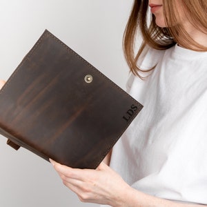 May include: A brown leather journal with the initials "LDS" embossed on the cover.