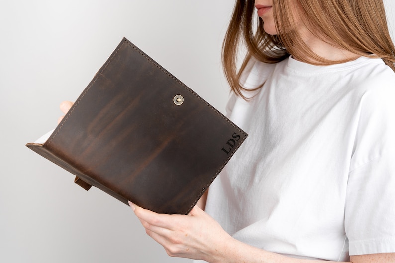 May include: A brown leather journal with the initials "LDS" embossed on the cover.