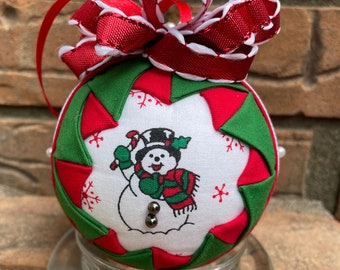 Traditional Christmas snowman ornament with candy cane for decorating. Winter holiday Decor for inside the home. Quilted no sew ornament.
