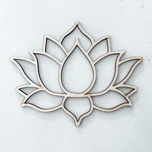 May include: A wooden cutout of a lotus flower. The cutout is a simple design with a single layer of wood.