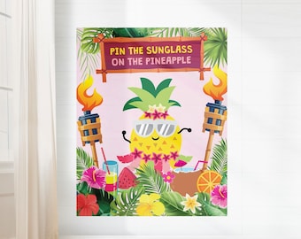May include: A pink and green game board with a cartoon pineapple wearing sunglasses. The text on the board reads "Pin the Sunglass on the Pineapple".