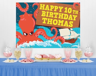 May include: A blue and white birthday party backdrop featuring a red octopus with a ship sailing on the ocean. The backdrop has the text "Happy 10th Birthday Thomas" on a wooden sign.